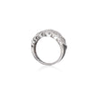 A white gold ring with a textured, scalloped top set with small clear stones, shown on a plain white background with a soft reflection below.