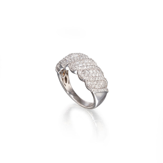 A silver pavé ring with a wavy, layered design, photographed on a clean white background with a soft reflection.