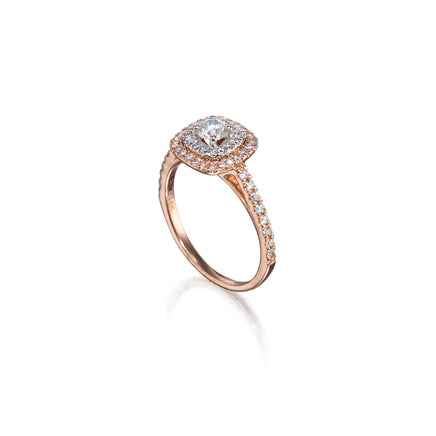 A rose gold halo ring with a round-cut center stone and small pavé-set stones along the band, shown on a clean white background with a soft reflection.