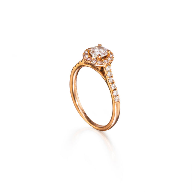 Rose Gold ring with a diamond on a white background