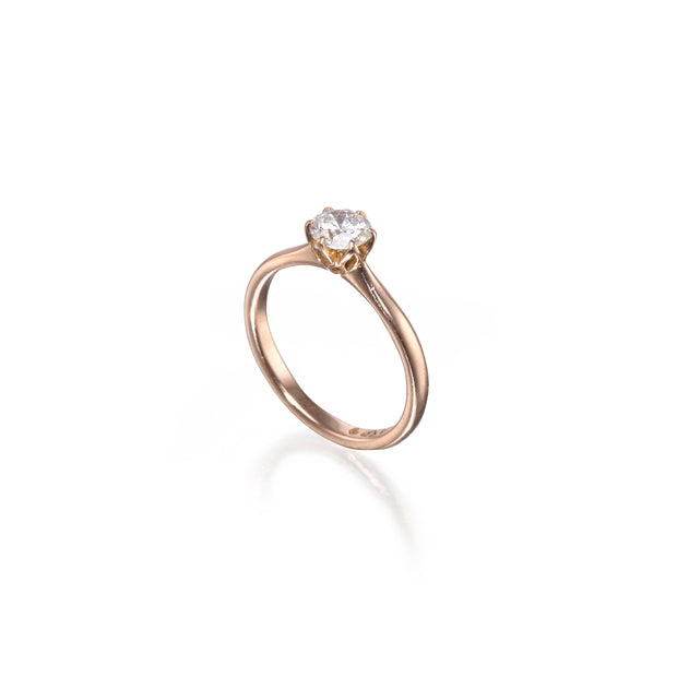 Gold ring with a diamond on a white background