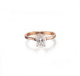 A rose gold engagement ring featuring an oval-cut diamond set in a four-prong setting, shown on a clean white background with a soft reflection.
