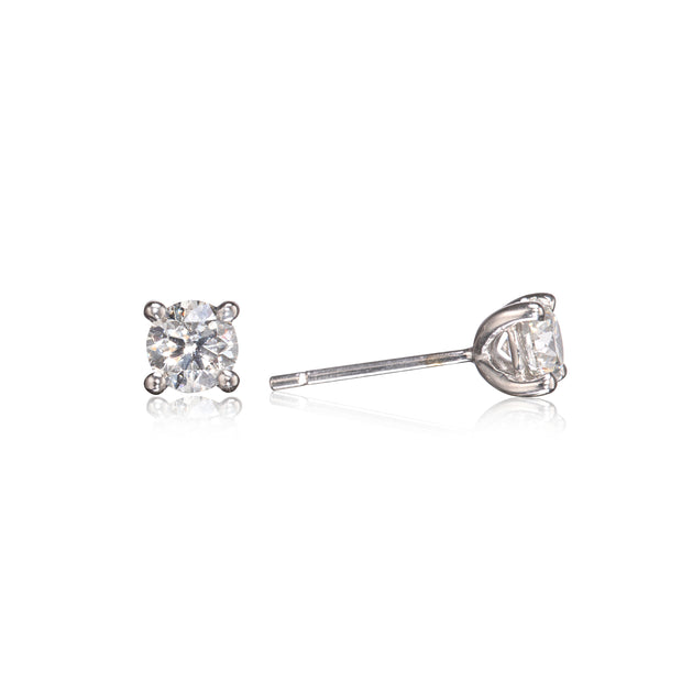A pair of white gold stud earrings with round-cut clear gemstones, shown from the front and side on a reflective white background.