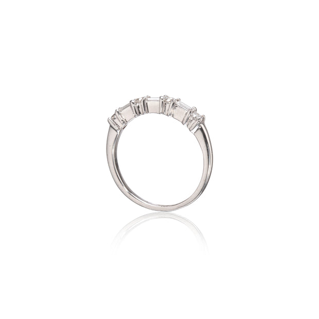 A white gold ring featuring a row of baguette-cut clear stones set across the top, shown against a plain white background with a soft reflection below.