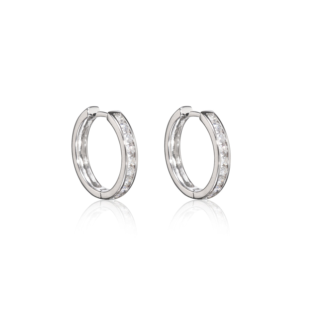 A pair of white gold hoop earrings with a row of clear stones along the front, displayed on a clean white background with a soft reflection below.