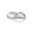 A pair of white gold huggie hoop earrings with a channel-set row of clear cubic zirconia stones, displayed on a clean white reflective surface.