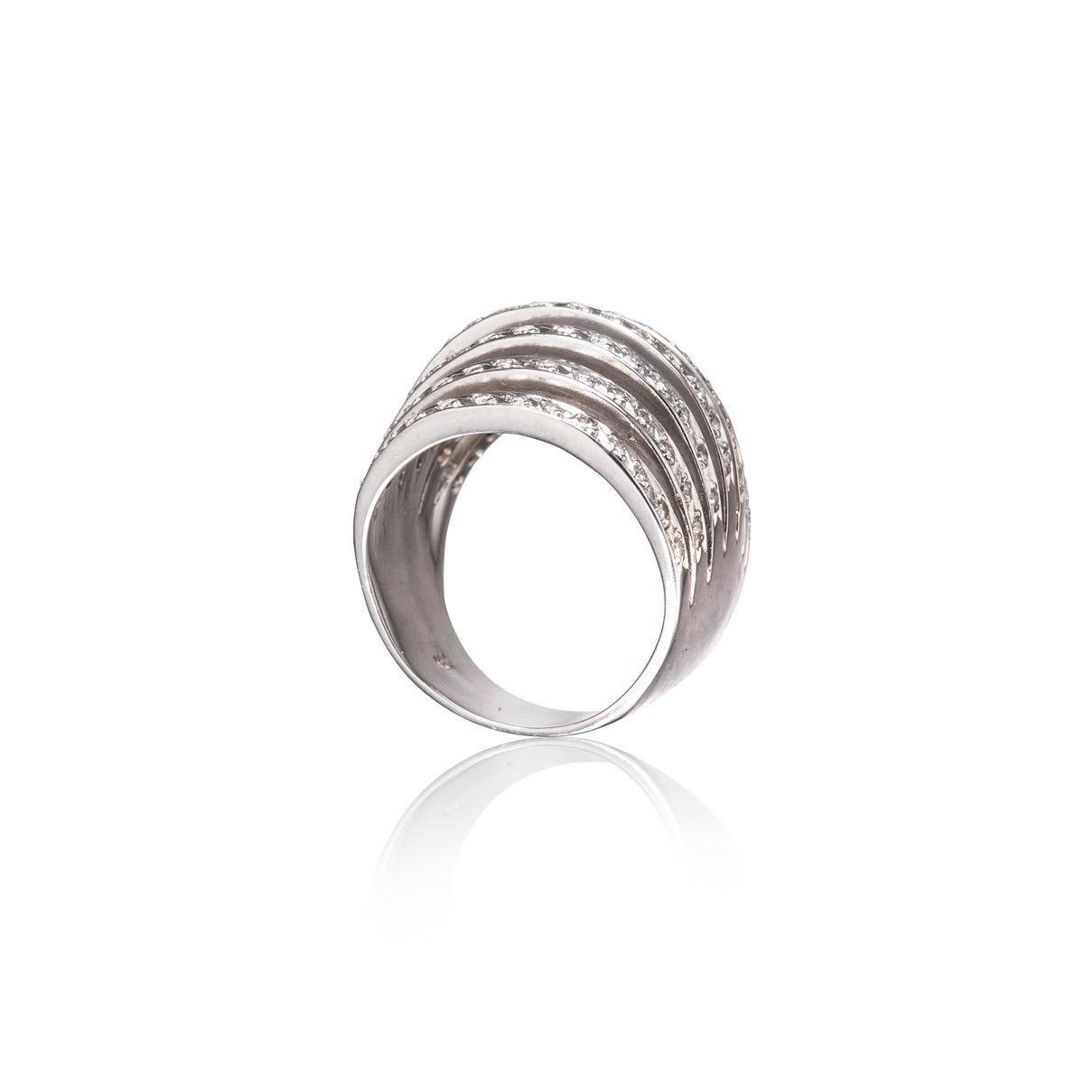 A white gold multi-band ring with rows of small clear stones, shown on a clean white background with a soft reflection below.