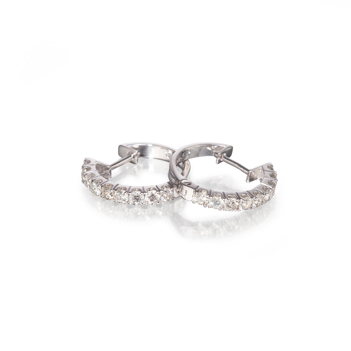 18ct White Gold Diamond Huggie Earrings on a white background