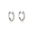 A pair of white gold huggie hoop earrings adorned with clear pavé-set round stones, shown on a clean white background with a soft reflection below.