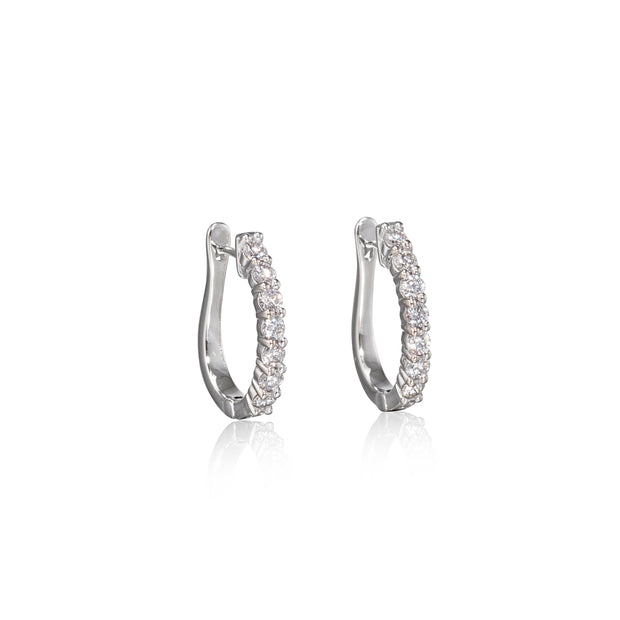 Pair of white gold hoop earrings with clear stones on a white background