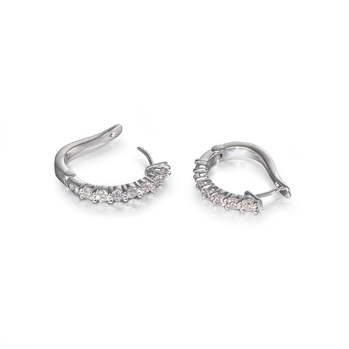 Pair of white gold hoop earrings with small diamonds on a white background