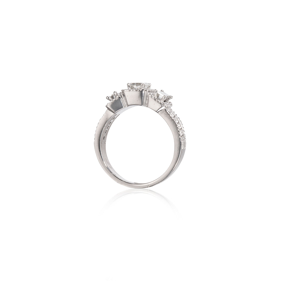 A white gold three-stone diamond ring shown from the side against a plain white background.