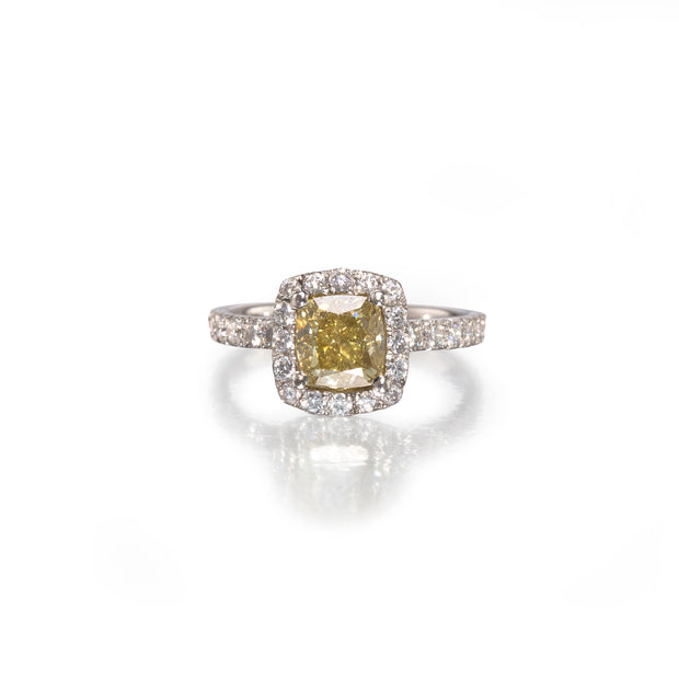 Diamond ring with a yellow diamond center stone on a white background