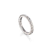 A white gold eternity ring with a full beaded band set with small clear round gemstones, shown on a clean white background with a soft reflection.