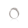 A white gold diamond ring shown from a side profile view on a clean white background with a soft reflection below.