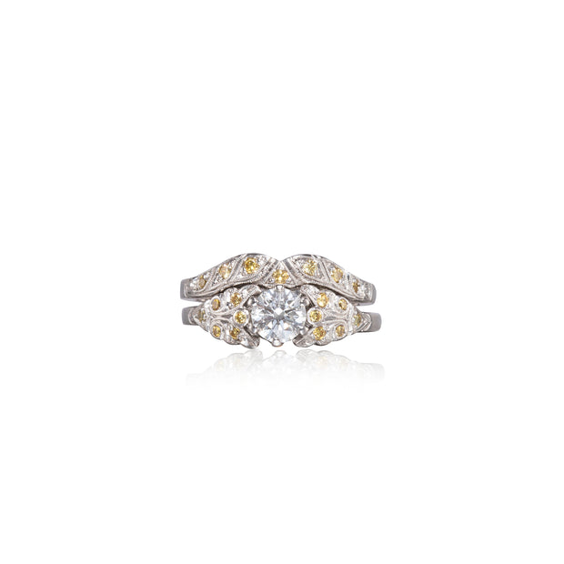 Two diamond rings with yellow and white stones on a white background