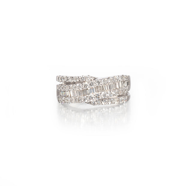 A white gold wrap-around ring with multiple rows of baguette and round-cut clear stones, shown on a clean white background with a soft reflection below.