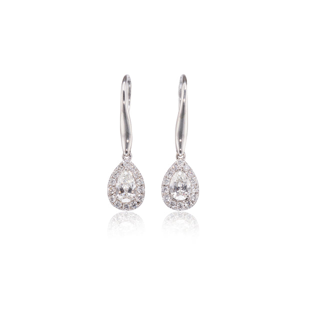 Pair of white gold teardrop earrings with clear stones on a white background