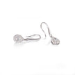 Pair of white gold teardrop earrings on a white background
