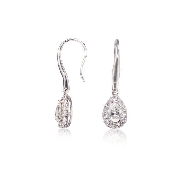 Pair of white gold teardrop earrings on a white background
