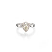 A pear-shaped diamond ring with a halo setting and a polished white gold band, centered on a clean white background with a soft reflection below.
