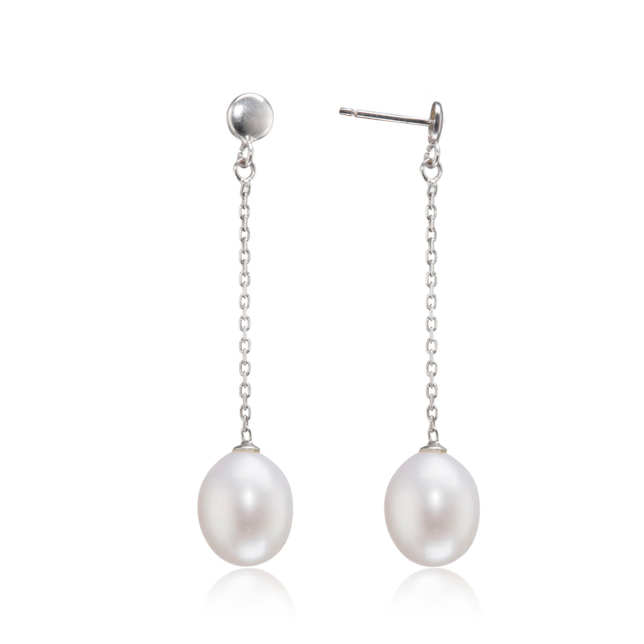 Pearl earrings with silver chains on a white background