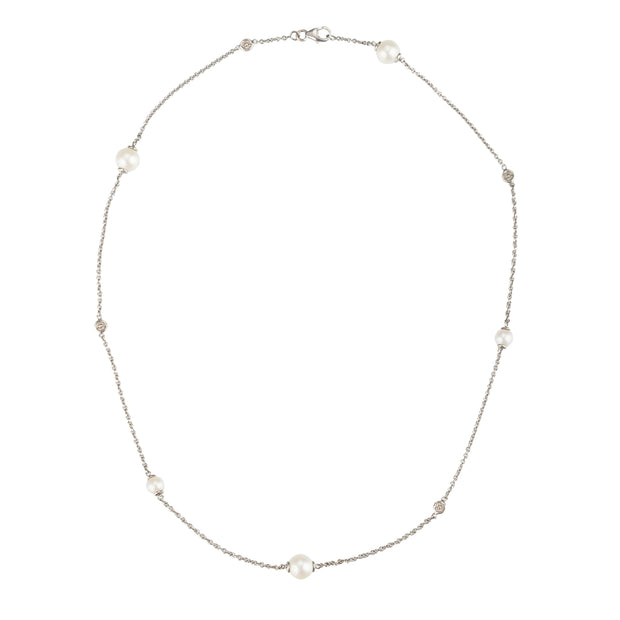A delicate white gold chain necklace featuring seven white freshwater pearls spaced evenly along the chain, displayed on a clean white background.