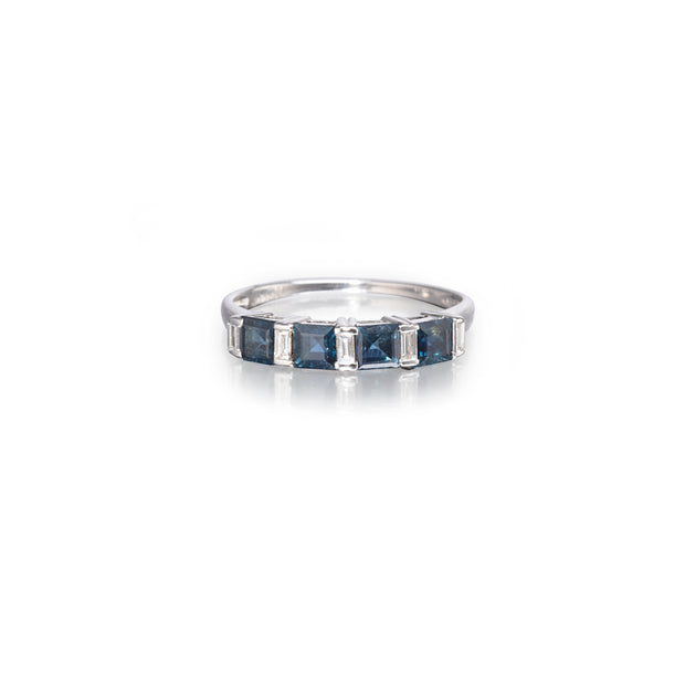 Silver ring with blue gemstones on a white background