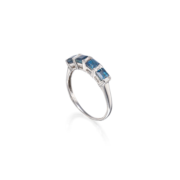 White gold ring with blue gemstones on a white background