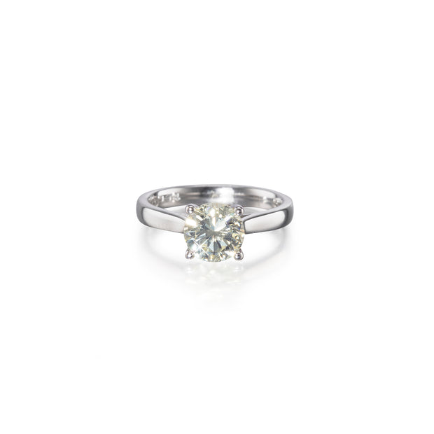 An 18ct white gold solitaire diamond ring with a round brilliant cut diamond set in a simple four-prong setting.