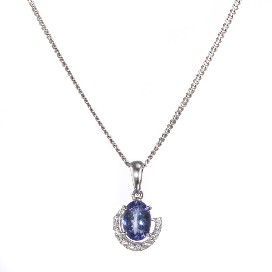 A white gold chain necklace with an oval blue gemstone pendant, surrounded by a crescent-shaped halo of small clear stones, shown on a plain white background.