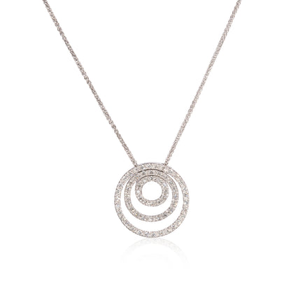 A white gold necklace featuring a multi-ring concentric spiral pendant paved with small clear stones, displayed on a clean white background with a soft reflection.