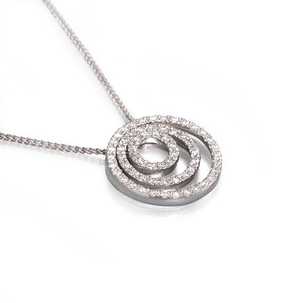 A white gold spiral pendant necklace paved with small clear stones, shown on a white background.