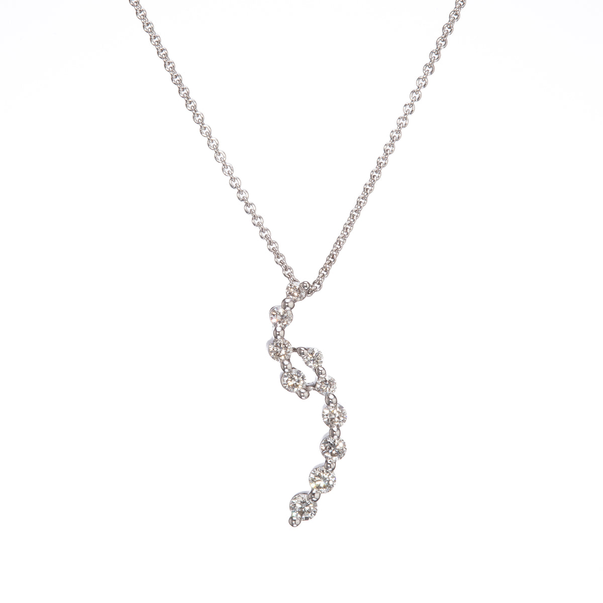 A delicate white gold chain necklace featuring a wavy, spiral pendant set with clear gemstones, shown against a plain white background.