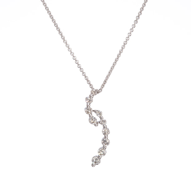 A delicate white gold chain necklace featuring a wavy, spiral pendant set with clear gemstones, shown against a plain white background.
