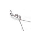 A white gold crescent-shaped necklace adorned with clear crystals, shown on a clean white background with a soft reflection.
