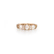 A vintage-style yellow gold ring featuring three large white pearls and small clear accent stones, set against a clean white background.