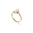 A yellow gold ring featuring a marquise-cut clear gemstone in a prong setting, with a small accent stone on the band, shown on a clean white background.
