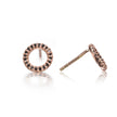 A pair of rose gold stud earrings with a circular halo design set with small black stones, shown on a reflective white background.