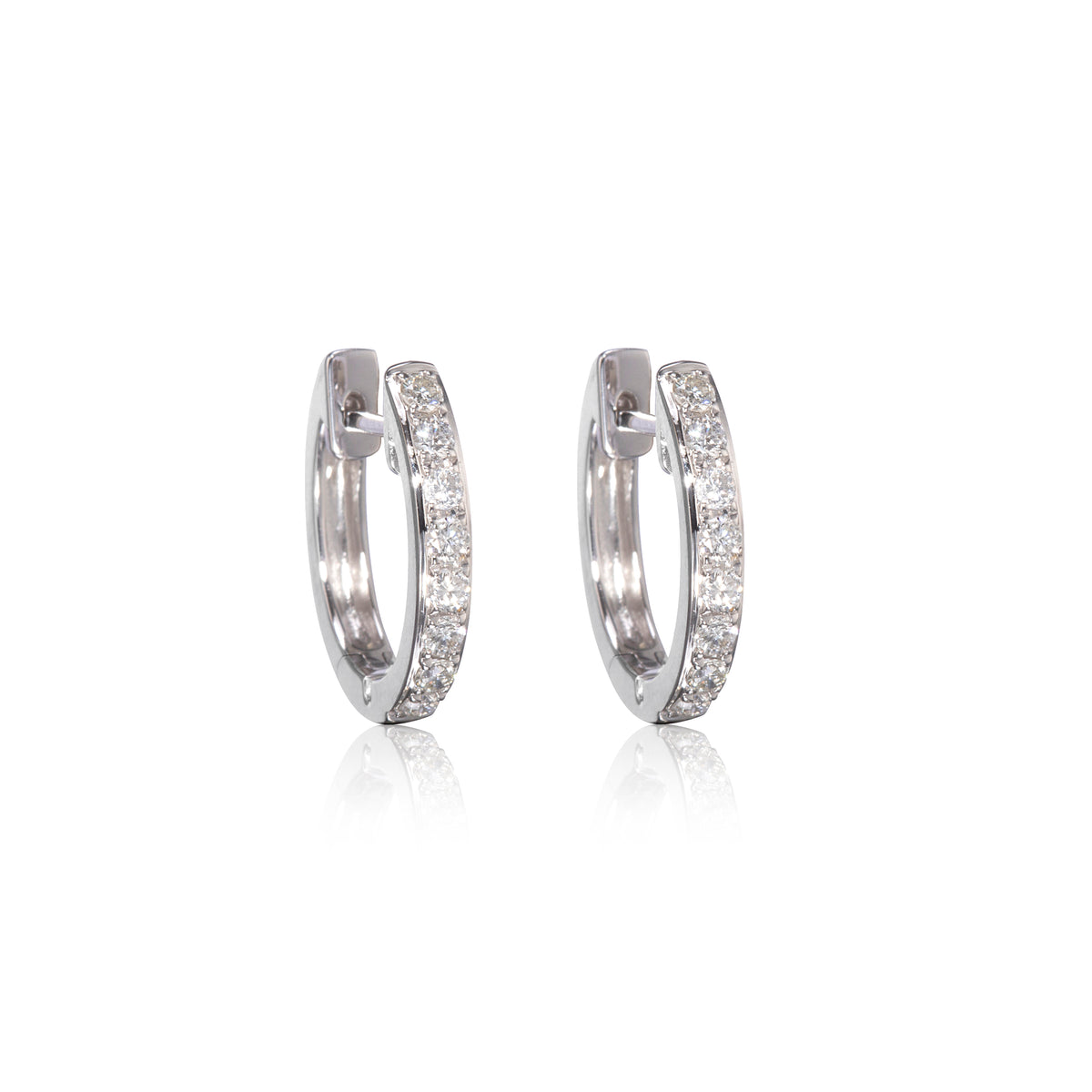 Pair of white gold diamond huggy earrings on a white background