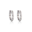 Pair of white gold diamond huggy earrings on a white background