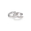 9ct White Gold Diamond Huggie Earrings laying flat