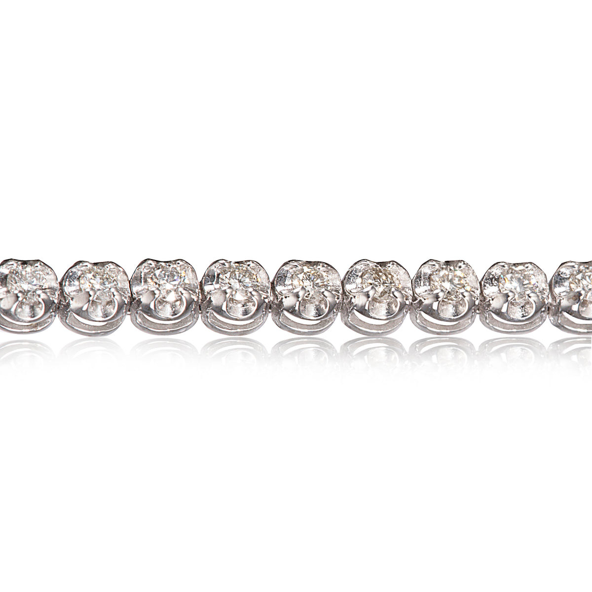 A close-up of a diamond tennis bracelet on a clean white background with a soft reflection below.