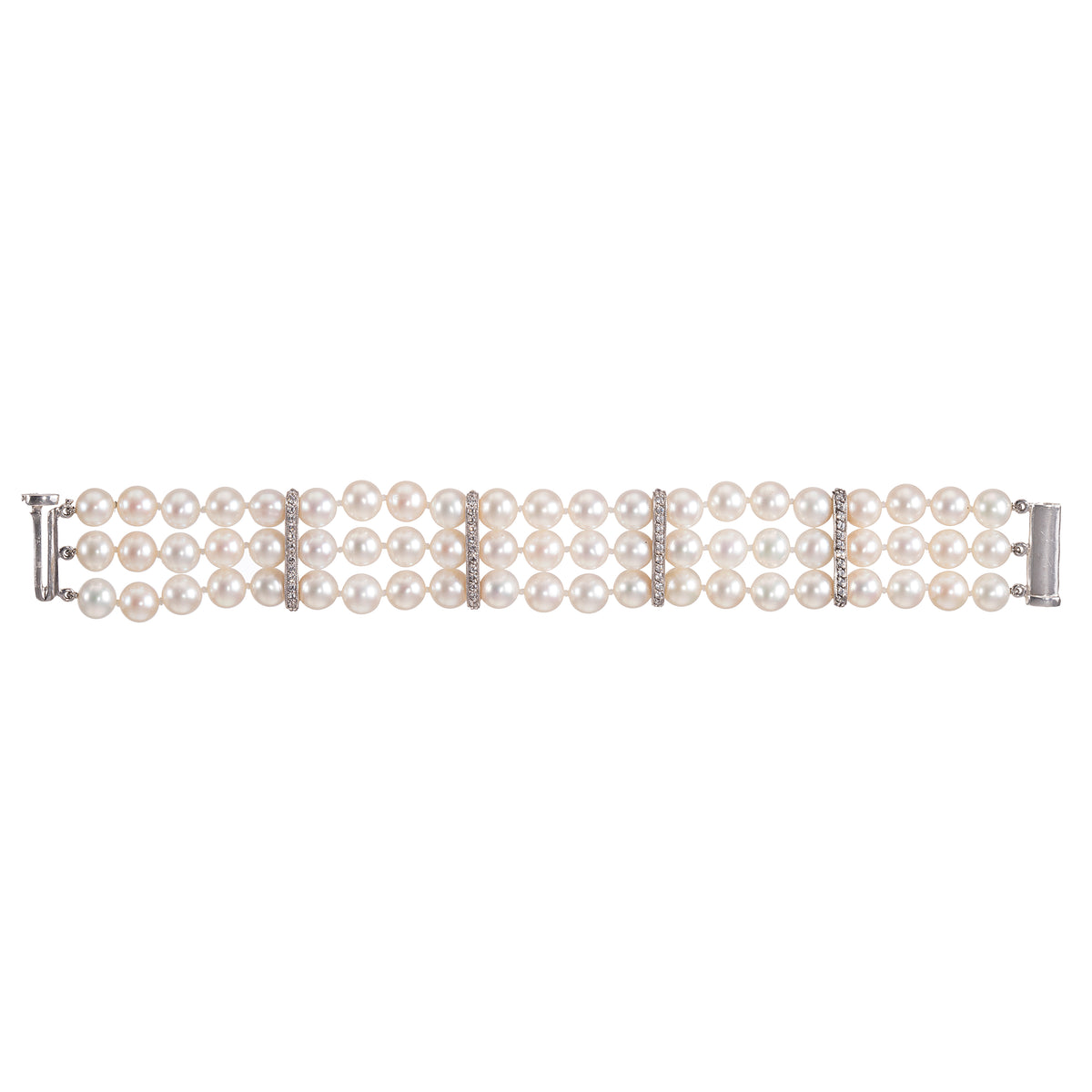 A white gold triple-row pearl bracelet with diamond accents between rows, displayed horizontally on a clean white background.