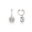 A pair of white gold drop earrings featuring cushion-cut clear gemstones surrounded by small pavé-set stones, shown on a clean white background with one earring facing forward and the other angled to show the side profile.