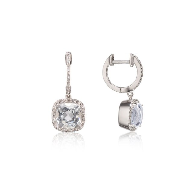 A pair of white gold drop earrings featuring cushion-cut clear gemstones surrounded by small pavé-set stones, shown on a clean white background with one earring facing forward and the other angled to show the side profile.