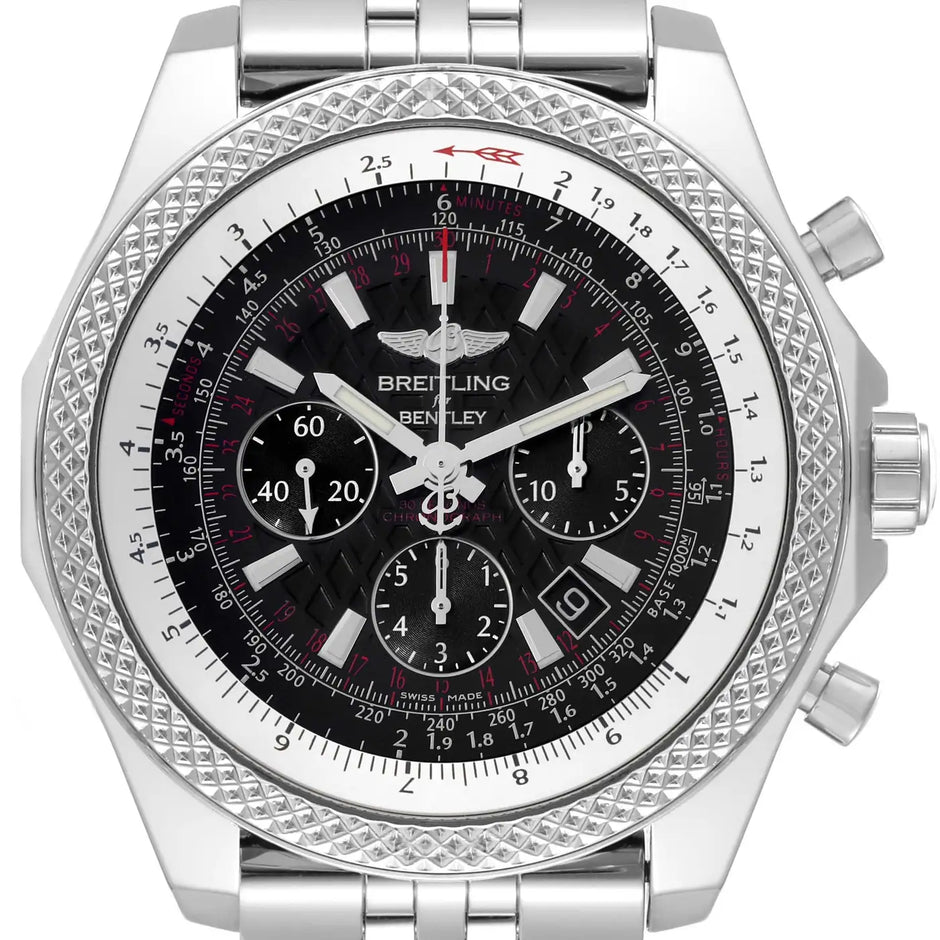 A Breitling chronograph watch with a silver-tone stainless steel case, a textured bezel, and a black dial with white and red details.