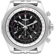 A Breitling chronograph watch with a silver-tone stainless steel case, a textured bezel, and a black dial with white and red details.