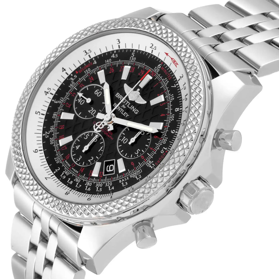 A stainless steel wristwatch with a textured bezel, a black dial with white and red accents, and a matching silver link bracelet, shown on a white background.