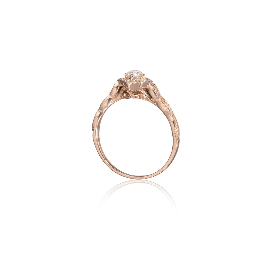 Gold ring with a diamond on a white background